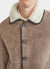 close up of light brown suede and white shearling coat with collar and buttons