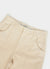close up of ecru wide leg trousers with embroidery of a green snail on right back pocket