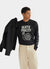 black long sleeve t shirt with white print of cartoon snail and text "quite pricey"