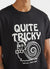 black short sleeve t shirt with white print of a cartoon snail and text "quite tricky"