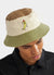 green, beige, brown and pink bucket hat with embroidery of a yellow chilli