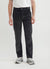 straight leg black corduroy trousers styled with grey sneakers and a white t shirt